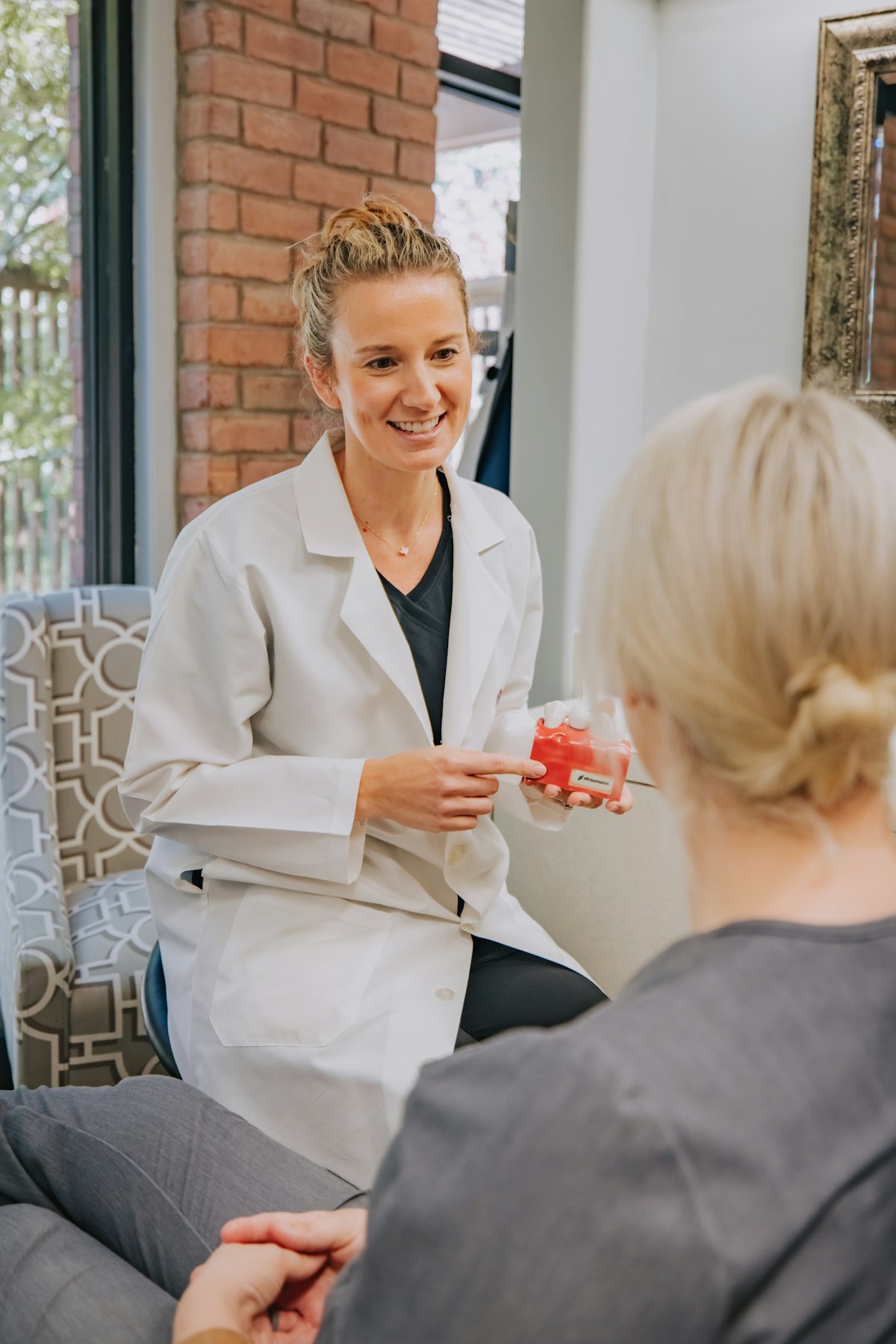 A doctor in a white coat with a stethoscope, smiling
