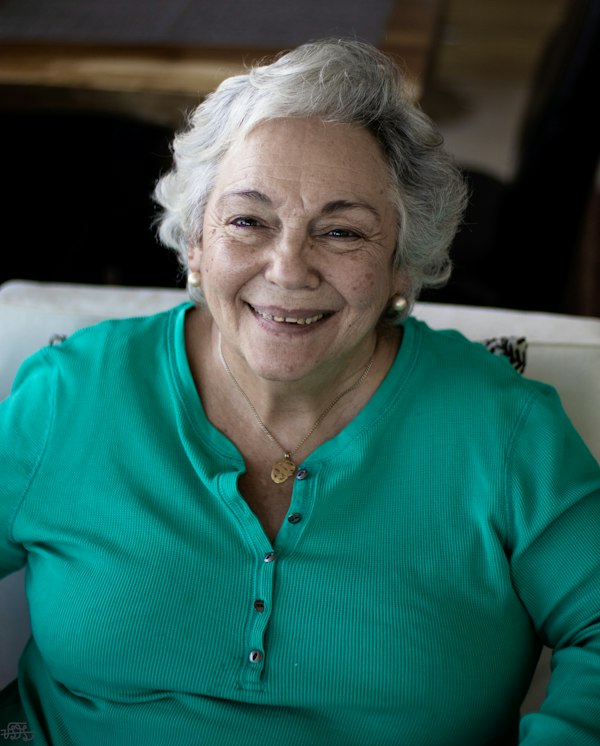 An older woman with gray hair smiling